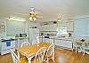 Kitchen/dining area. The main room of the cottage is one big family room. Big open kitchen, dining room tables and family area. Bright and cheerful, freshly renovated.