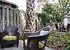The back yard and garden features two separate seating areas with large unbrellas. The yard is not fenced in, however there's plenty of area to play and relax.