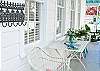 The wrap around screen porch is a great place to relax and enjoy Tybee