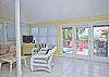 Glass entry doors at Doyle's on the Beach along with wonderful large windows allow you to enjoy the gorgeous beach views from indoors! This is the spacious living area with view of deck and beach.