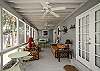 The screened porch has lots of outdoor seating including a table for 4-6.