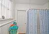 The 1st floor bathroom is a full bathroom.  This is a jack and jill bathroom accessable via the two bedrooms on either side.