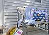 The fully enclosed back yard has a table and chairs ( with umbrella), seating and outdoor art. The outer building in the enclosed backyard/ courtyard also includes the laundry room.