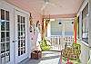 Bright, colorful screened porch awaits you at Barefoot Children!