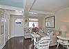 The first floor living room area is a combination of the living room with sofa and cable TV, dining room area with table that seats 6 people.
