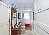 This bathroom features a old fashioned claw footed bathtub/shower combination.