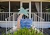 This is the front of the cottage which shows how large the screened porch is- clear across the front! The sign is custom-made by local artist, Pam Martin. An original creation!