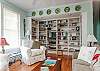 The cottage has a very open layout. This is the large family room with cable TV and library, dining room and even the kitchen. There is also a wood burning fireplace. Tall ceilings and lots of natural lighting.