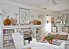 The fireplace mantel has original art, sea shells and other treasures from the sea.  The sofa and chairs are covered in custom made slipcovers