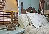 More details of the 2nd floor bedroom.  We love the wicker sofa, brass twin bed and beautiful dark wood floors