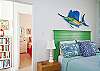 Large second bedroom features a queen bed.  This photo shows both master bedroom and second bedroom.