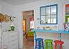 Views of the spacious, open living and dining area. Bright, colorful and fun! This area includes a bar with extra seating; fun place to sit and have a snack!