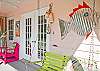 Bright, colorful screened porch awaits you at Barefoot Children!