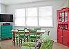 Dining area and cute, colorful hutch.