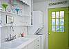 Views of the bright, cheerful kitchen which is on back of cottage through the living area.