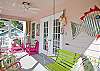 Bright, colorful screened porch awaits you at Barefoot Children!