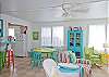 Views of the spacious, open living and dining area. Bright, colorful and fun! This area includes a bar with extra seating; fun place to sit and have a snack!