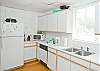 Kitchen area. The main room of the cottage is one big family room. Big open kitchen, dining room tables and family area. Bright and cheerful, freshly renovated.