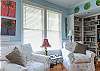 The cottage has a very open layout. This is the large family room with cable TV and library, dining room and even the kitchen. There is also a wood burning fireplace. Tall ceilings and lots of natural lighting.