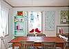 Dining table with seating for 8. Fun blue/white polka-dot chandelier!