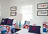 Our cheerful bedroom! Red, white and nautical blue! One double and one twin bed.
