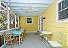The screened porch has lots of seating as well as a large farm style table and chairs to enjoy meals or playing games.