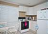 The studio apartment kitchen area. A full size stove/oven and refrigerator. Basic kitchen equipment including coffee maker.