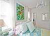 The bedroom also features a vintage chandelier