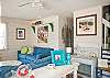 Large, open, bright family room with denim beach-friendly furniture &amp; flatscreen TV.