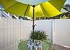 The back yard has seating and unbrella. This area connects to the private pool and has just the right amount of room for sunbathing in the private back yard if you need a break from the beach or for that late afternoon ice tea break!