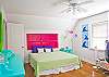 Bedroom #2 upstairs; features a king bed and TV.  Lots of bright, fun color and great natural light!