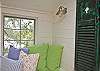 Pillows all over the seat make for a very cozy seating area.  The vintage shutters are part of our wall art .