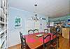 The cottage has a very open layout.  This is the large family room with cable TV and library, dining room and even the kitchen.  There is also a wood burning fireplace. Tall ceilings and lots of natural lighting.