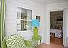 The screened porch is across the front of the cottage. Full of lime green wicker.