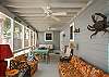 The screened porch has lots of outdoor seating including a table for 4-6.