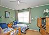 This bedroom has two twin beds as well as cable TV.