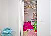 Reading nook in master bedroom; fun pink patchwork decor with shelving for books and cute chandelier!