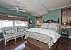 The queen bedroom is on the 2nd floor and has cable TV. The master bathroom on the 2nd floor is also off this bedroom.  The bedroom has one queen bed and one twin bed.