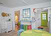 Views of the spacious, open living and dining area. Bright, colorful and fun! This area includes a bar with extra seating; fun place to sit and have a snack!