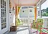 Bright, colorful screened porch awaits you at Barefoot Children!