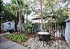 The back yard and garden features two separate seating areas with large unbrellas. The yard is not fenced in, however there's plenty of area to play and relax.