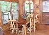 The beautiful cedar dining table provides seating for up to 7 guests