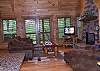 Luxury Sofa and Chair centered around the Flat Screen HDTV and the gas log fireplace in the Living Room.