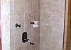 "Custom Tile Showers with Body Spray Shower Heads in All Three Bathrooms. The lower level shower is also a steam shower