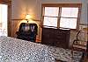 This view of the master bedroom shows you the reading area provided in the recliner or the rocking chair for your relaxation.