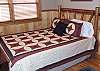 In the third bedroom located also on the Main Floor of the cabin there is also a Queen Log Bed.