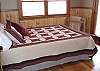 This is the 2nd of 3 bedrooms on the Main Floor of the cabin.  This bedroom offers a Queen Bed with door exiting onto the large deck