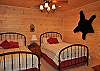 There are 2 queen beds in the bedroom on the lower level of the cabin provides enough room for 4 more guests. Perfect for your extra family members.