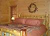 Beautiful King Size Cedar Log Bed in the Master Bedroom with adjoining Bathroom and Private Dec,