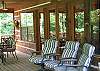 You can enjoy the river from the covered porch on the front of the cabin. There is plenty of seating and also a dining table for your outdoor meals.